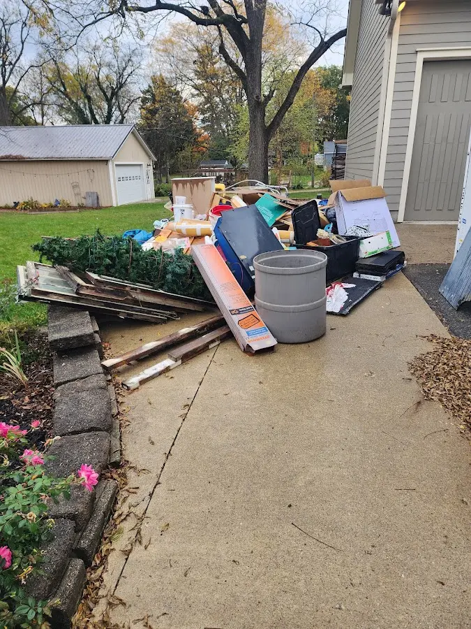 Dumpster being loaded with debris for 10 Yard Dumpster Rental in Maryville